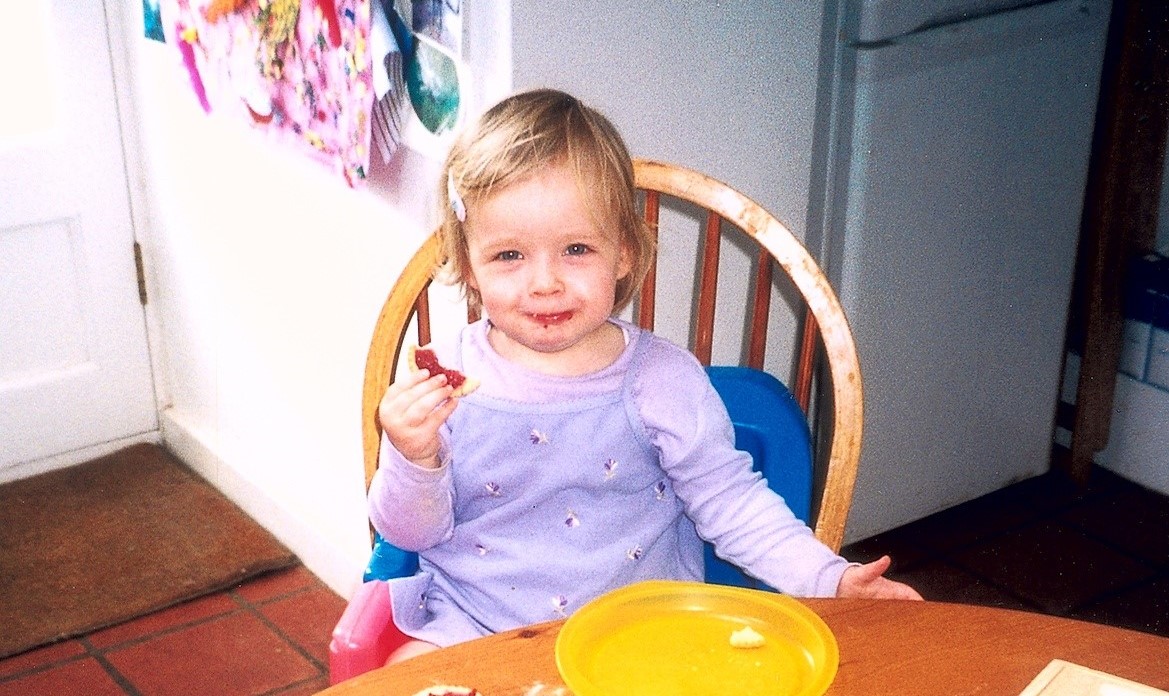 A child eating a jam tart