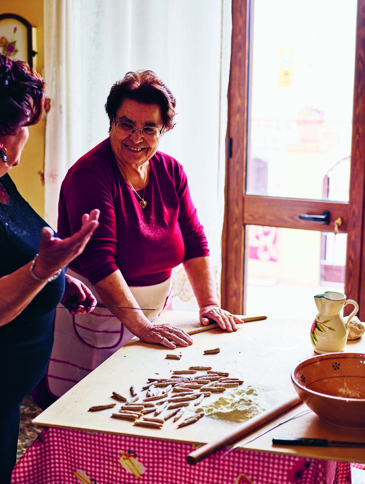 Beatrice rolling pasta dough. Pasta Grannies.
