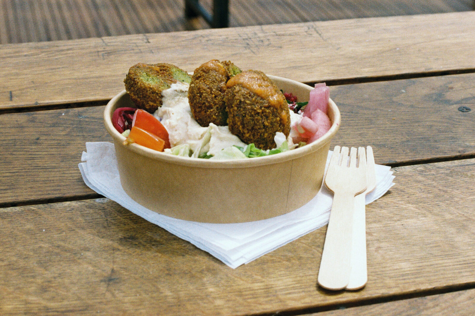 Falafel and salad in a takeaway pot.