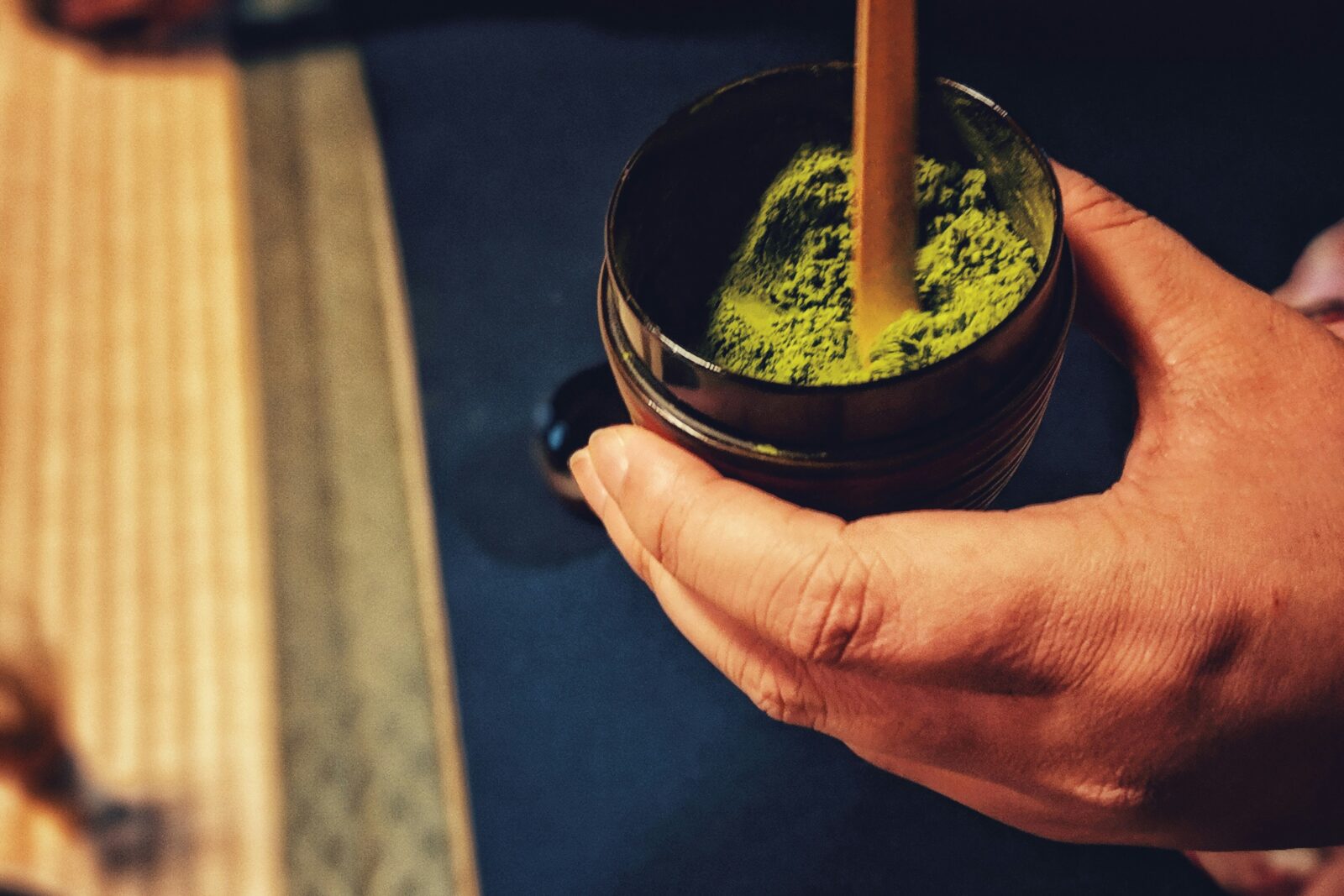 Matcha powder and wooden matcha spoons.